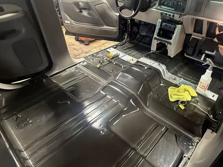 SUV with the seats and carpet removed down to the bare metal floor during mold cleanup